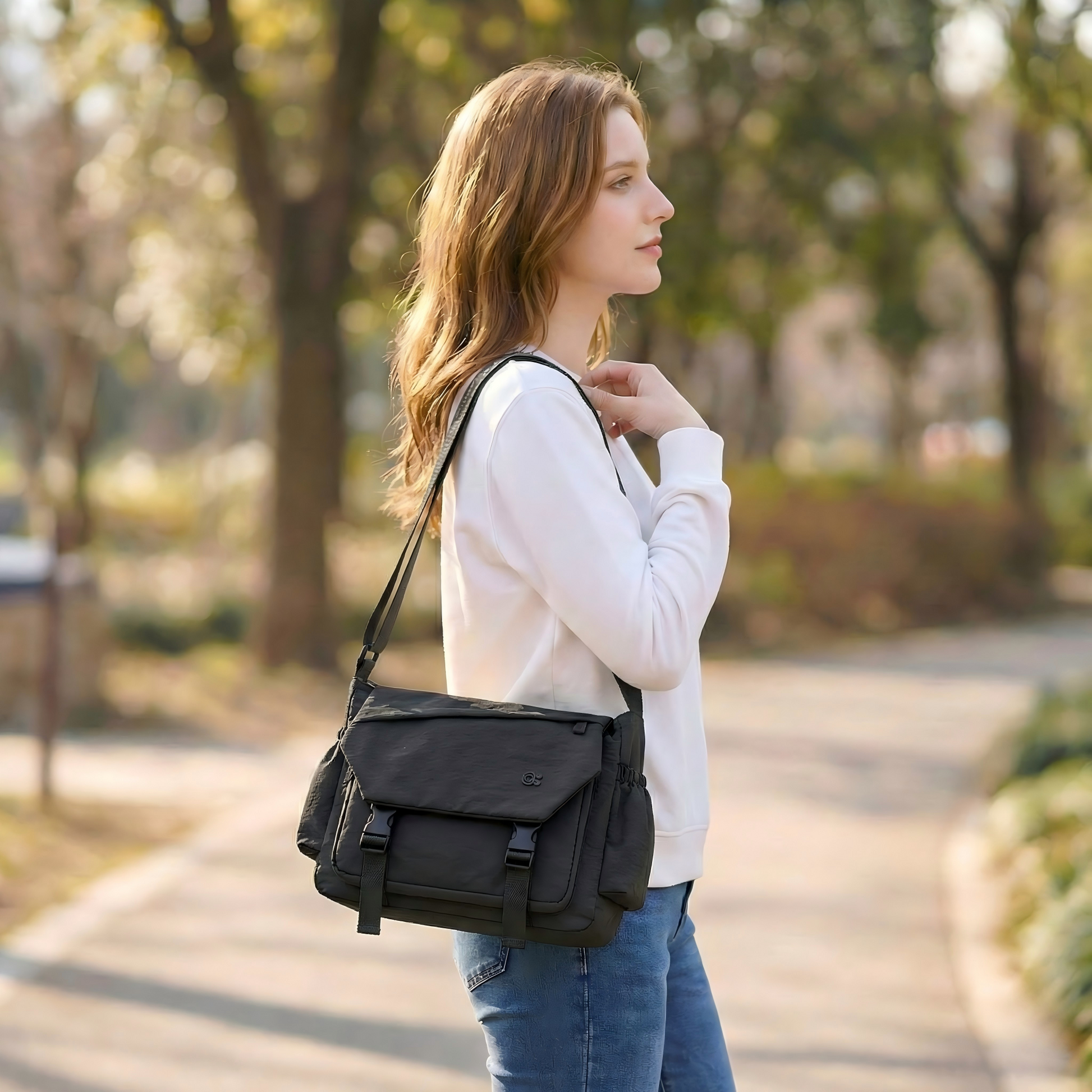 Woman walking outdoors with a black shoulder bag