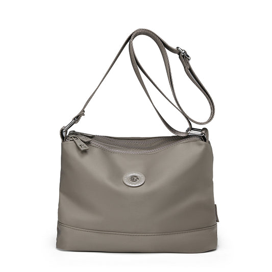 Women's Lightweight Water-Repellent Crossbody Bag – Compact Multi-Zipper Shoulder Purse with Branded Woven Strap